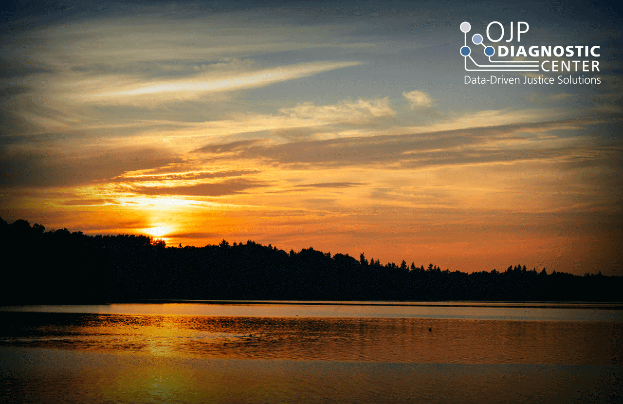 Scenic image of a lake with red sunset in the background of OJP Diagnostic Center logo